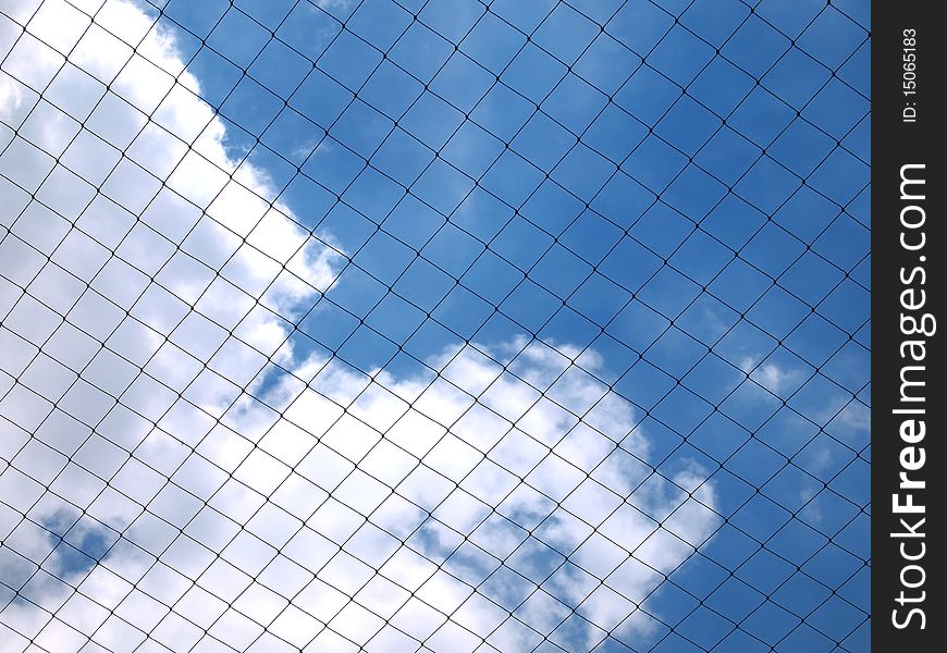 Blue sky behind fishing net