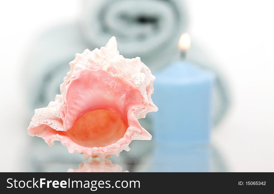 Seashell and candle with spa towels