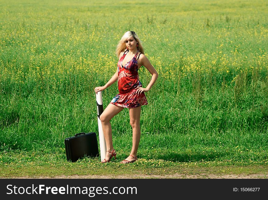 Woman with a suitcase. Outdoor shooting.