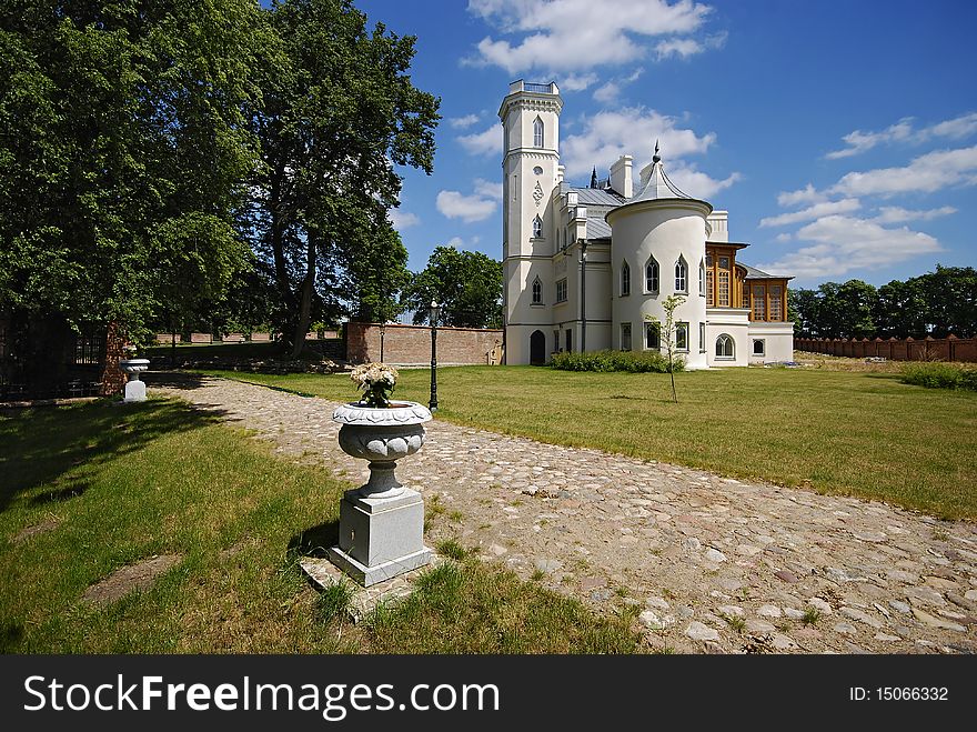 Gothic palace with the garden into a sunny day. Gothic palace with the garden into a sunny day