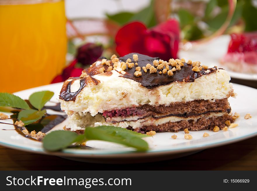 Sweet chocolate dessert with nuts in shape of triangle with juice