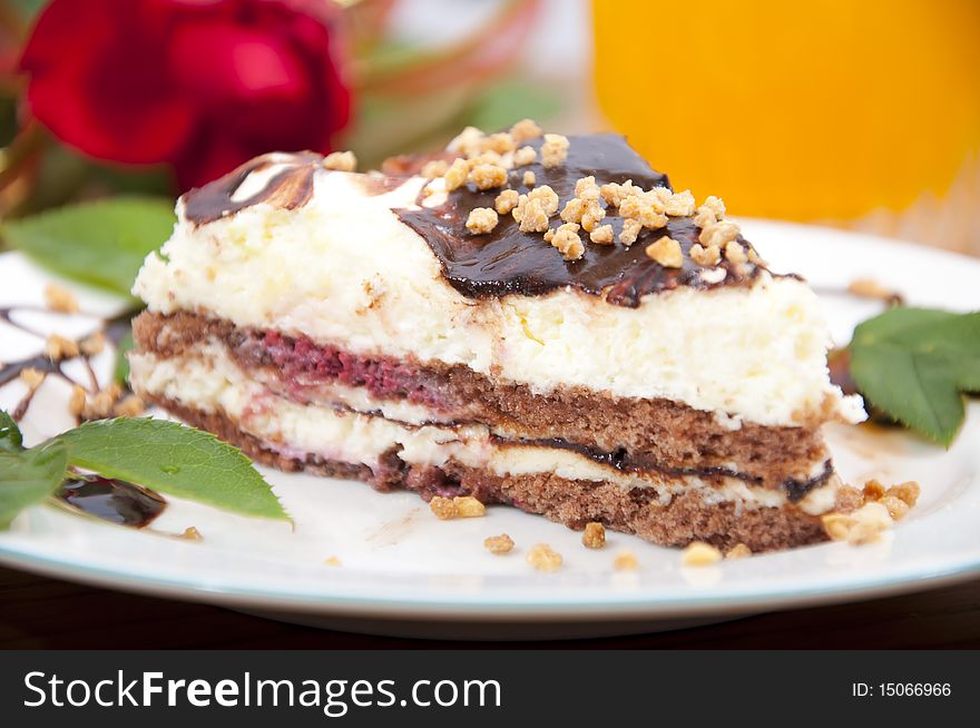 Sweet chocolate dessert with nuts in shape of triangle with juice