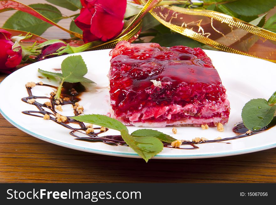 Sweet raspberry and strawberries dessert with chocolate on white plate