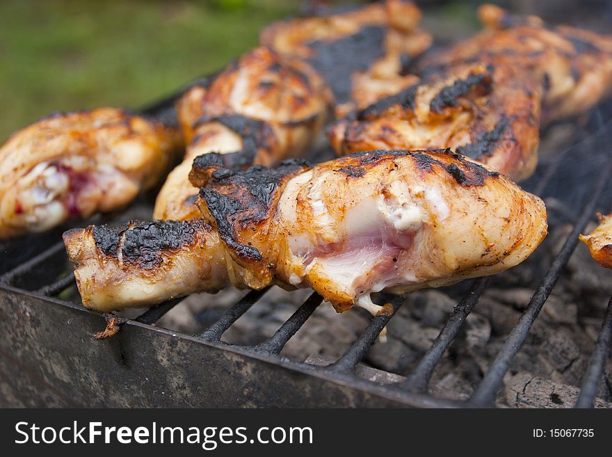 Roasted chicken thighs on the grill with grill marks on them. Roasted chicken thighs on the grill with grill marks on them