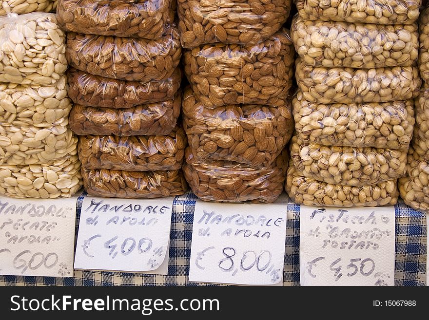 Almonds and pistachios for sales on a market table