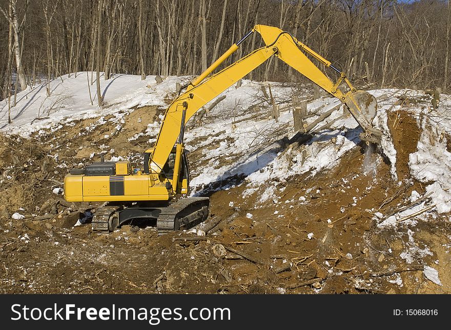 Excavator on construction of the road in mountain