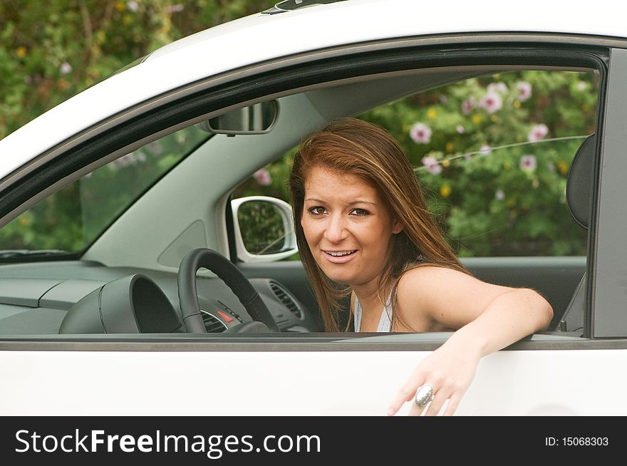 Teen girl driver in automobile looking out the window with a stressful expression. Teen girl driver in automobile looking out the window with a stressful expression