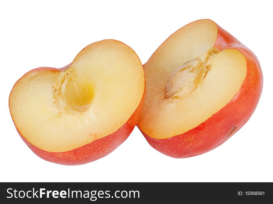 Plum cut fifty-fifty with pit on white background