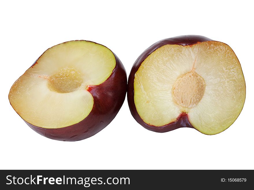 Plum cut fifty-fifty with pit on white background. Plum cut fifty-fifty with pit on white background
