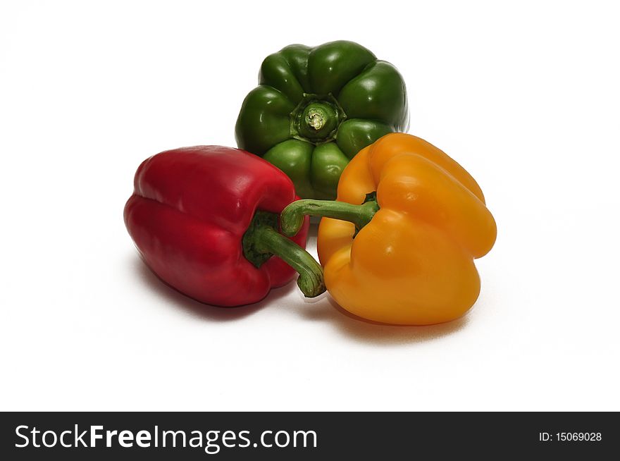 Three bell peppers isolated against a white background