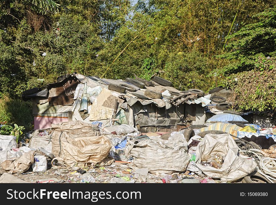 Sacks and sacks of garbage in front of a shanty