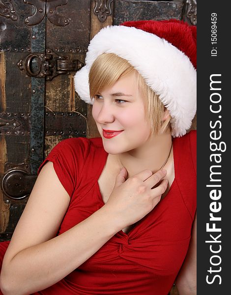 Beautiful young blond female wearing a fluffy christmas hat. Beautiful young blond female wearing a fluffy christmas hat