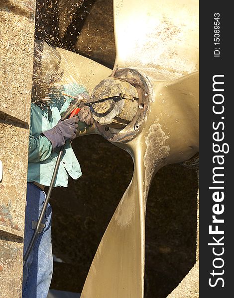 Arc welder arcing a strap off of a tug boat wheel. Arc welder arcing a strap off of a tug boat wheel