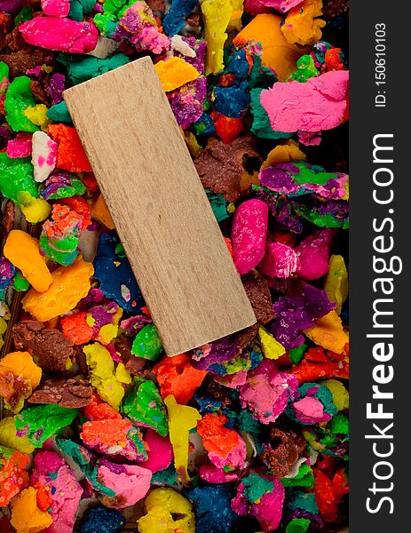 Piece of wood on dried colorful play dough