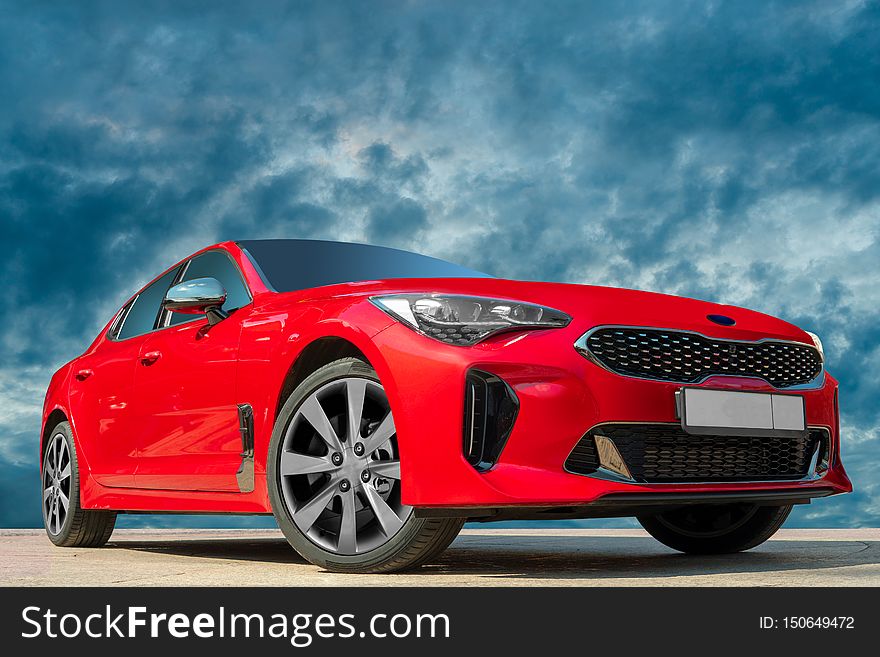 Red car on blue sky background.