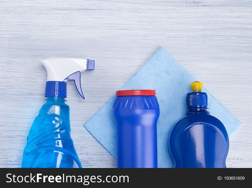 On A Light Background, Blue Cloth And Blue Bottles With Powder And Surface Cleaning Fluids