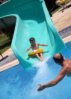 Father Catches Child On Water Slide Stock Photo