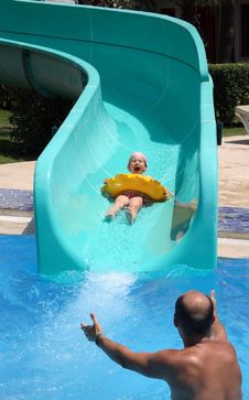 Father Catches Child On Water Slide Stock Photos Father Catches Child On Water Slide Stock Photos