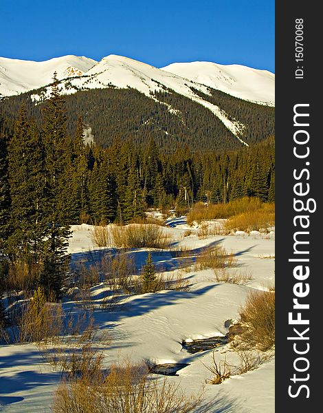 A small stream is starting to thaw out below Berthoud Pass in Colorados Front range Mountains. A small stream is starting to thaw out below Berthoud Pass in Colorados Front range Mountains