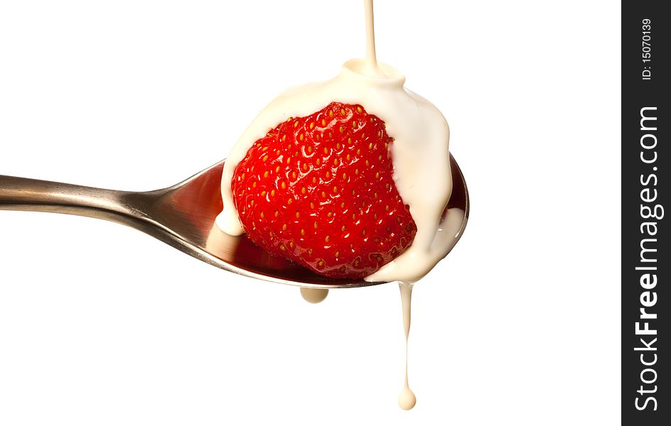 Strawberry with fresh cream being poured over it. Strawberry with fresh cream being poured over it.