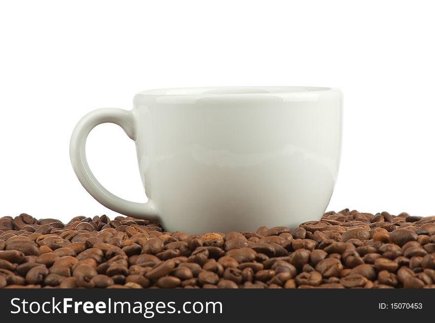 Coffee beans and a cup isolated on white background