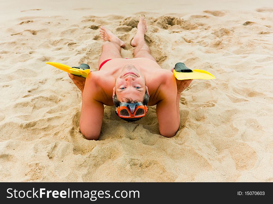 Beach sitting man with flippers. Beach sitting man with flippers