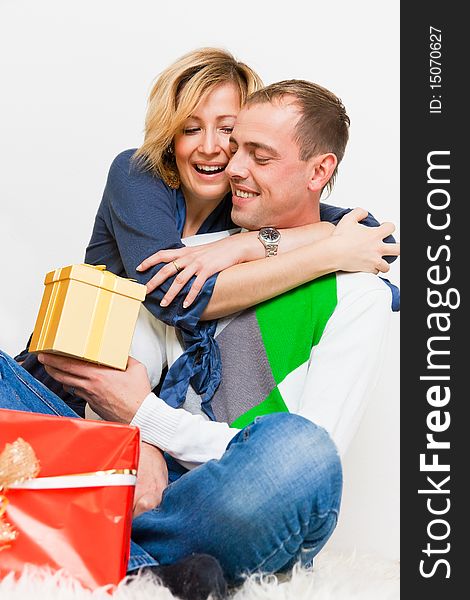 Young lovely happy couple embracing with presents. Young lovely happy couple embracing with presents