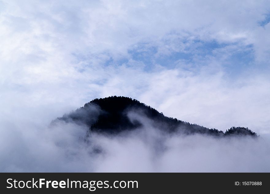 Mountain growth from low clouds. Bad weather for trekking. Mountain growth from low clouds. Bad weather for trekking.