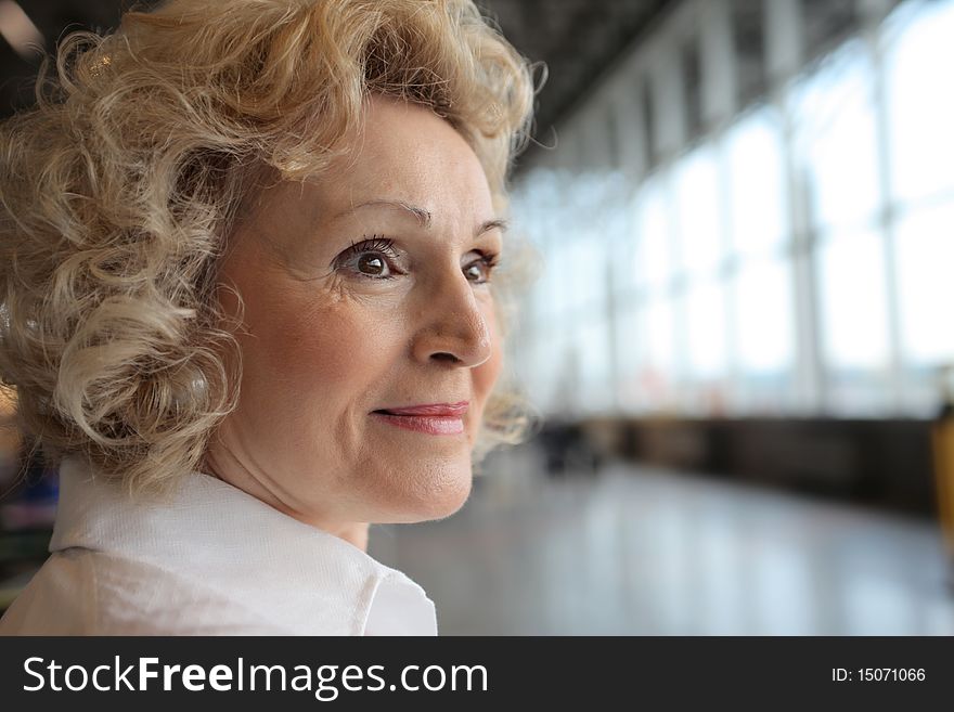 Portrait of a smiling senior woman at the airport. Portrait of a smiling senior woman at the airport