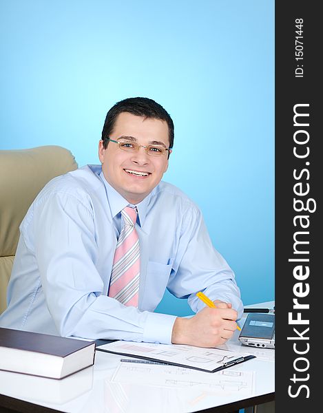 Businessman at work. On blue background.