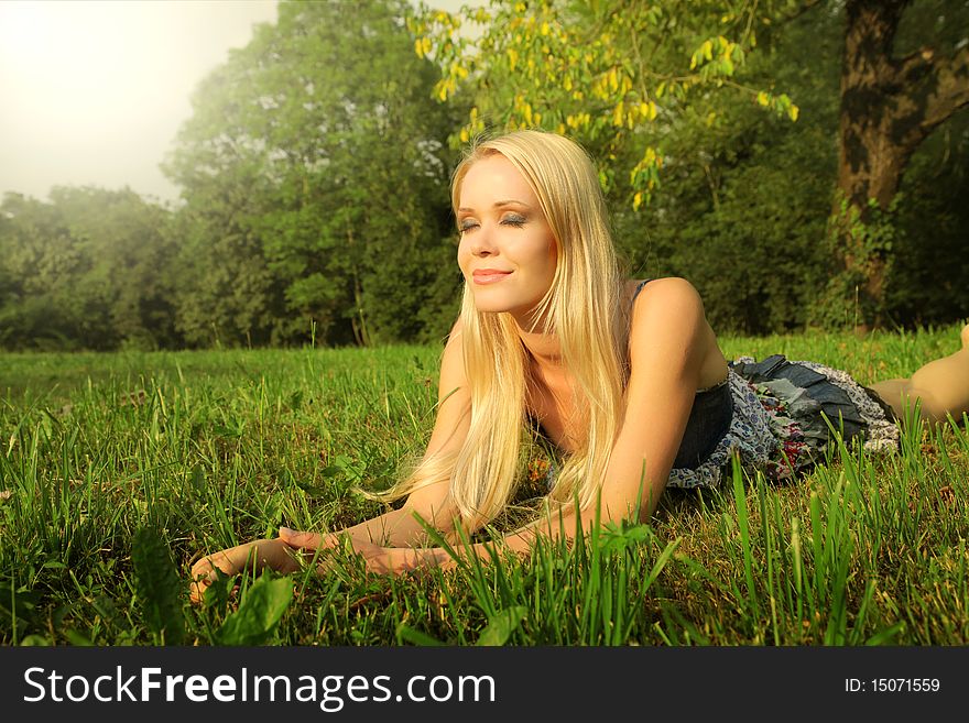 Beautiful woman lying on the grass. Beautiful woman lying on the grass