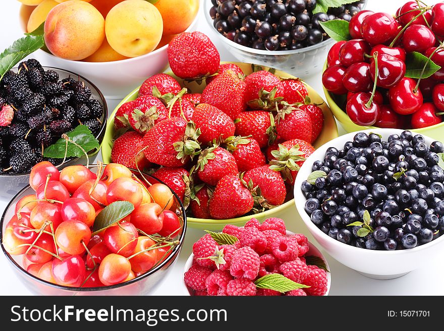 Different berries in bowls. In white dishes. Different berries in bowls. In white dishes