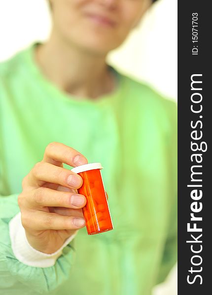 Doctor holding bottle of prescription pills with hand