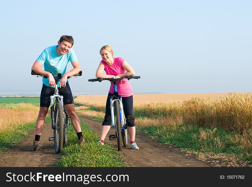 Two cyclists relax biking outdoors