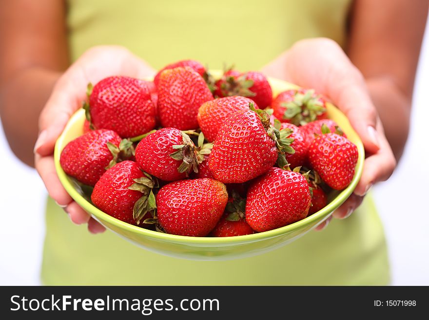 Crockery with strawberries in woman hands. Crockery with strawberries in woman hands.