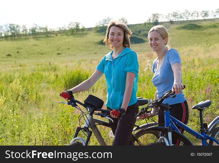 Two cyclists relax biking outdoors