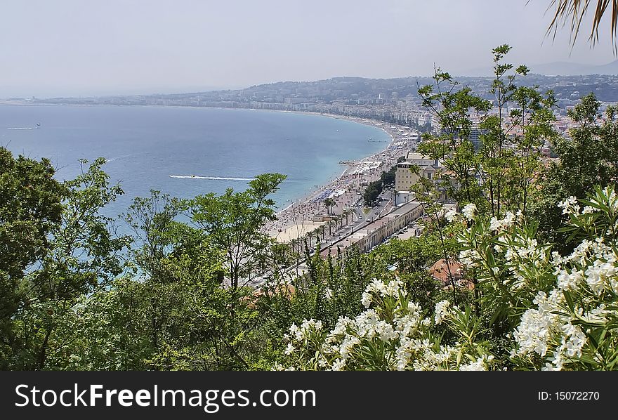 View from trees to Nice, famous beach. View from trees to Nice, famous beach