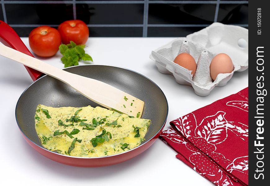 A freshley cooked herb omelette in a frying pan