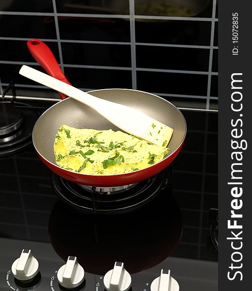 A freshley cooked herb omelette in a frying pan