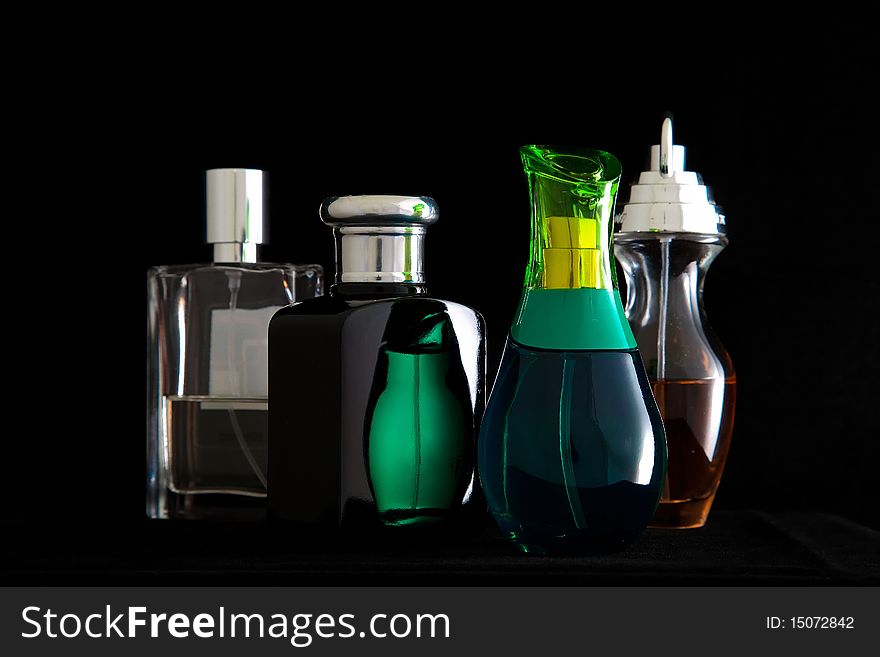 Small perfume bottles arranged on a table. Small perfume bottles arranged on a table.