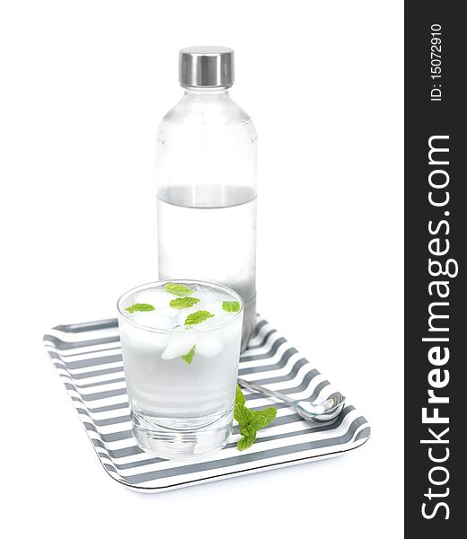 Mint flavoured carbonated water on a serving tray isolated against a white background. Mint flavoured carbonated water on a serving tray isolated against a white background