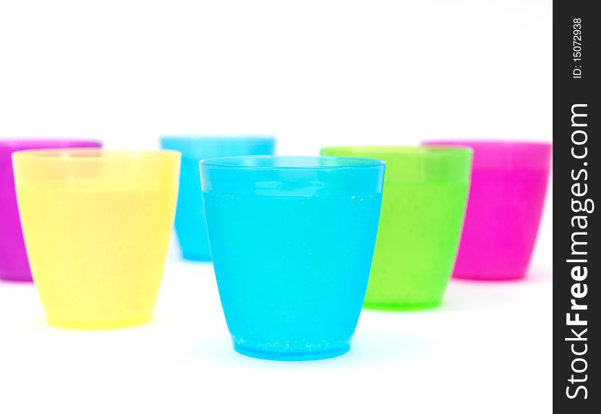 Plastic cups filled with carbonated water isolated against a white background. Plastic cups filled with carbonated water isolated against a white background