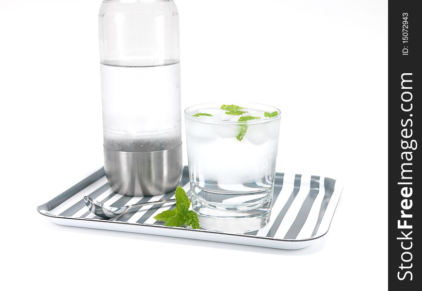 Mint flavoured carbonated water on a serving tray isolated against a white background. Mint flavoured carbonated water on a serving tray isolated against a white background