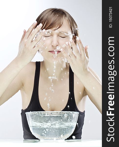 Young woman washing her face