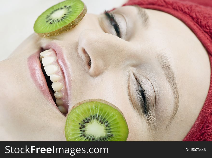Girl with kiwi on her face