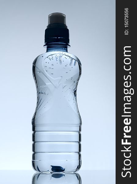 Purified mineral water on the wet glass desk with reflection