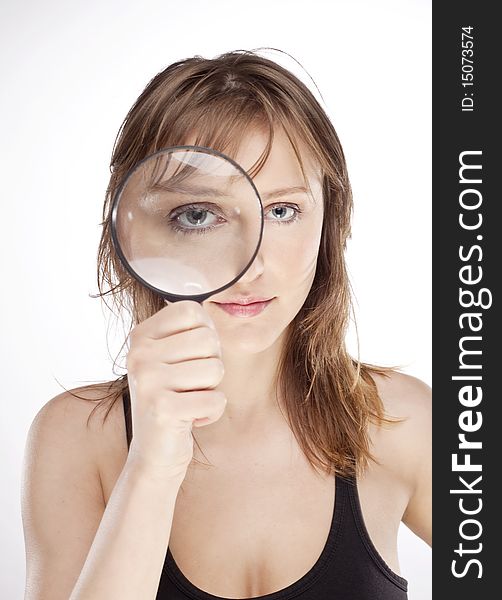 Portrait of woman with magnifier lens on eye isolated on white