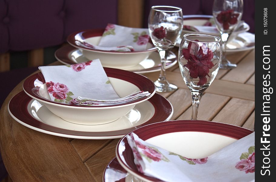 A table setting with glasses and plates. A table setting with glasses and plates