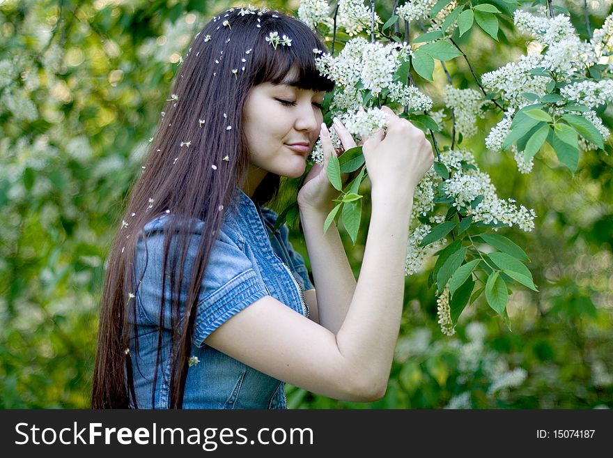 Girl standing near lilac