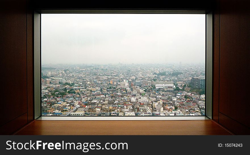 A view of the residential area of Tokyo through a window of a tower building in Setagaya. A view of the residential area of Tokyo through a window of a tower building in Setagaya